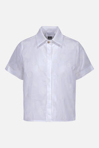 La chemise Norah à pois blancs confectionnée à partir d'un tissu à motif carotté importé du Japon. Chaque exemplaire est cousu avec soin à Montréal.